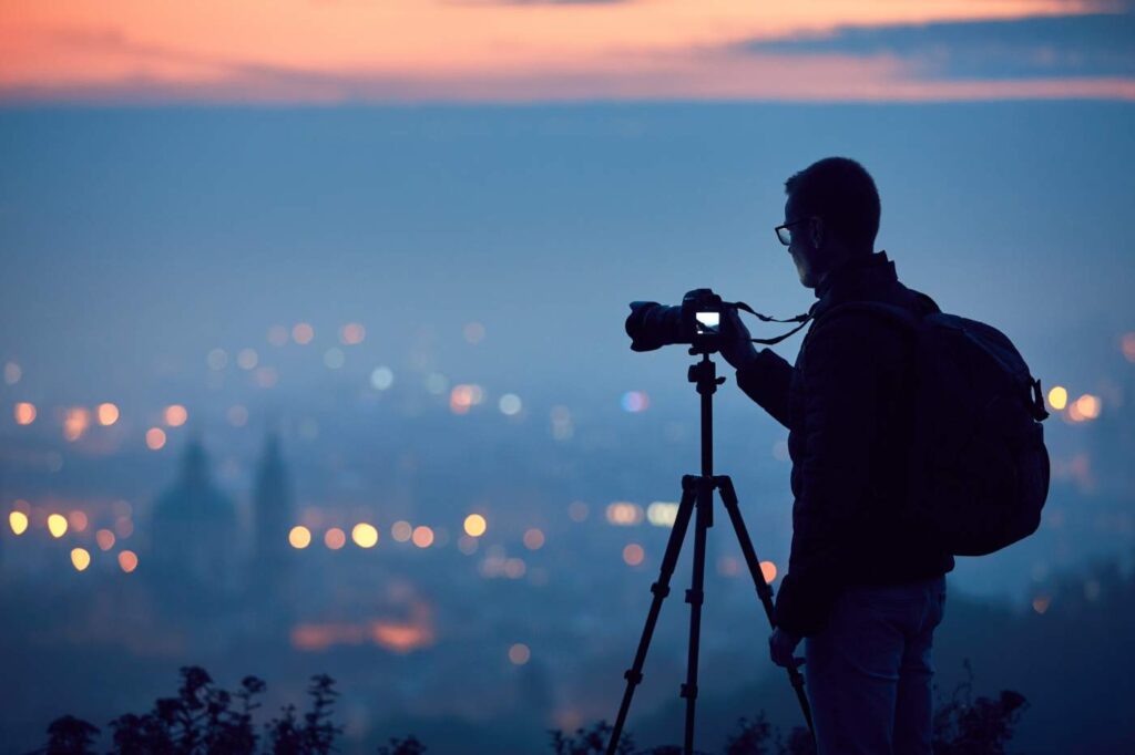 Photographer using camera tripod